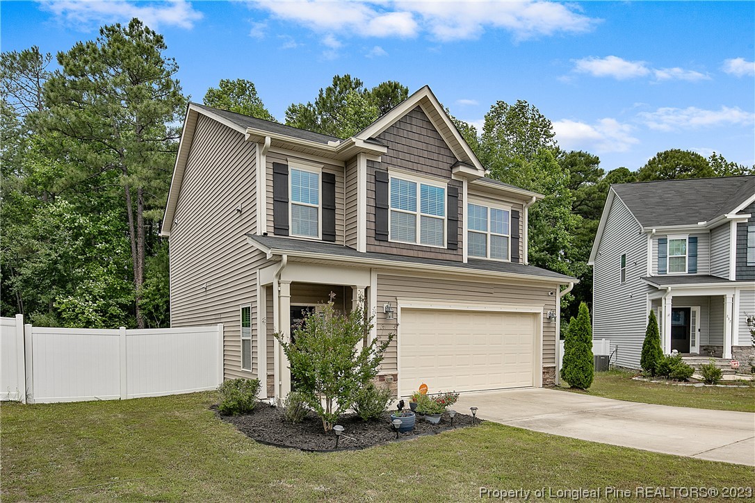 233 Blue Bay Lane Cameron, NC 28326 - Photo 3 of 50 a front view of a house with a yard and garage