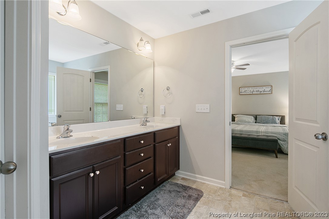 233 Blue Bay Lane Cameron, NC 28326 - Photo 33 of 50 a en suite bathroom with a double vanity sink a mirror and a shower