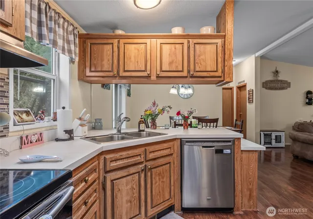 a kitchen with stainless steel appliances granite countertop a sink and cabinets