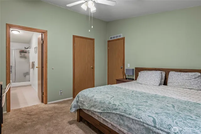 a bedroom with a large bed and a chandelier
