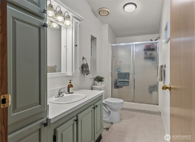 a bathroom with a sink toilet and shower