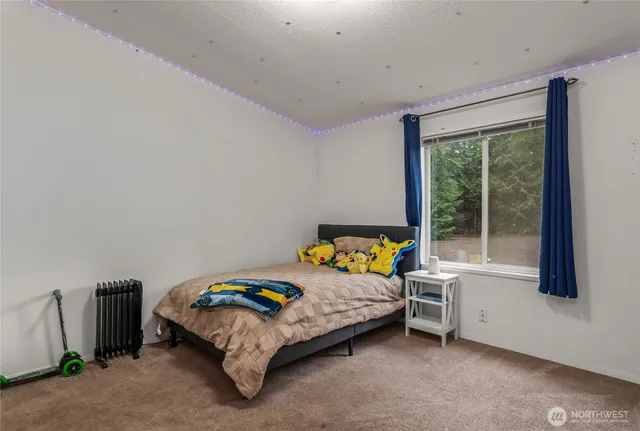 a bed sitting in a room next to a window