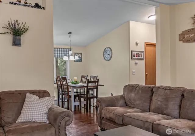 a living room with furniture wooden floor and a chandelier