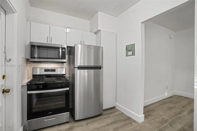 a kitchen with a refrigerator stove and microwave