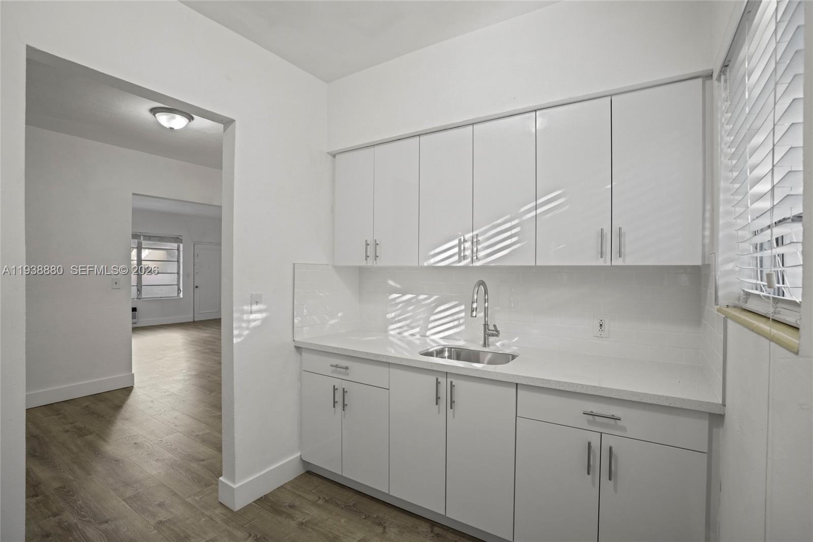 4172 Chase Avenue, Unit 3 Miami Beach, FL 33140 - Photo 14 of 29 a kitchen with white cabinets