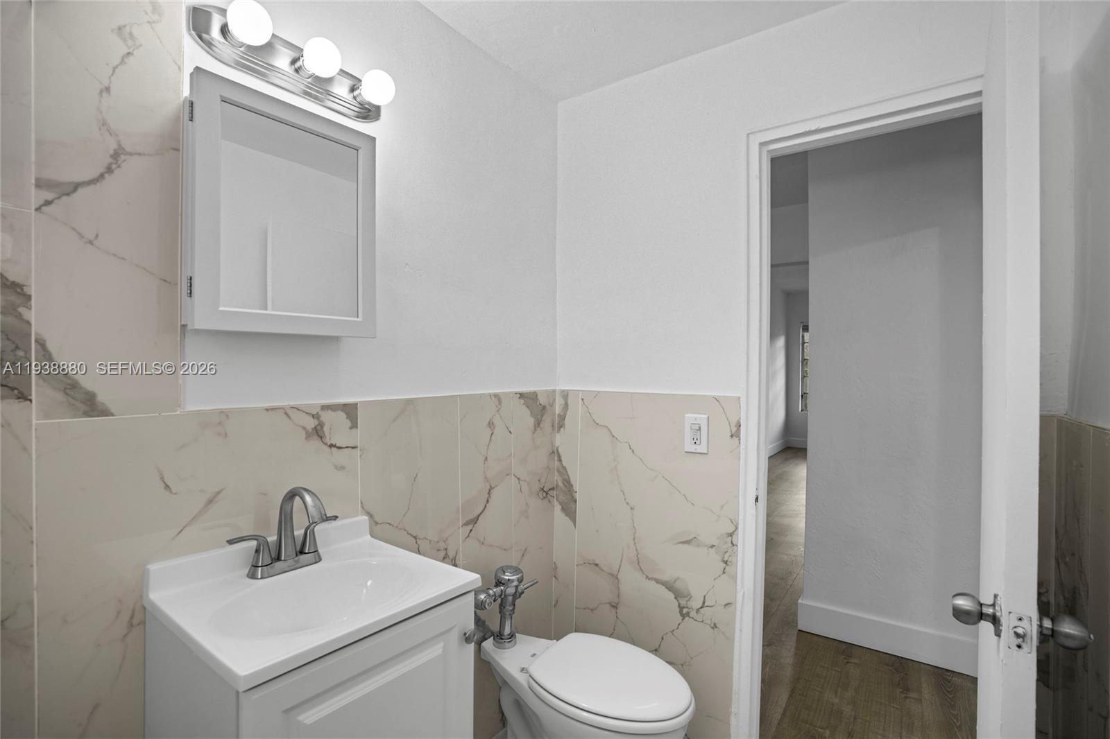 4172 Chase Avenue, Unit 3 Miami Beach, FL 33140 - Photo 18 of 29 a bathroom with a sink vanity mirror and toilet