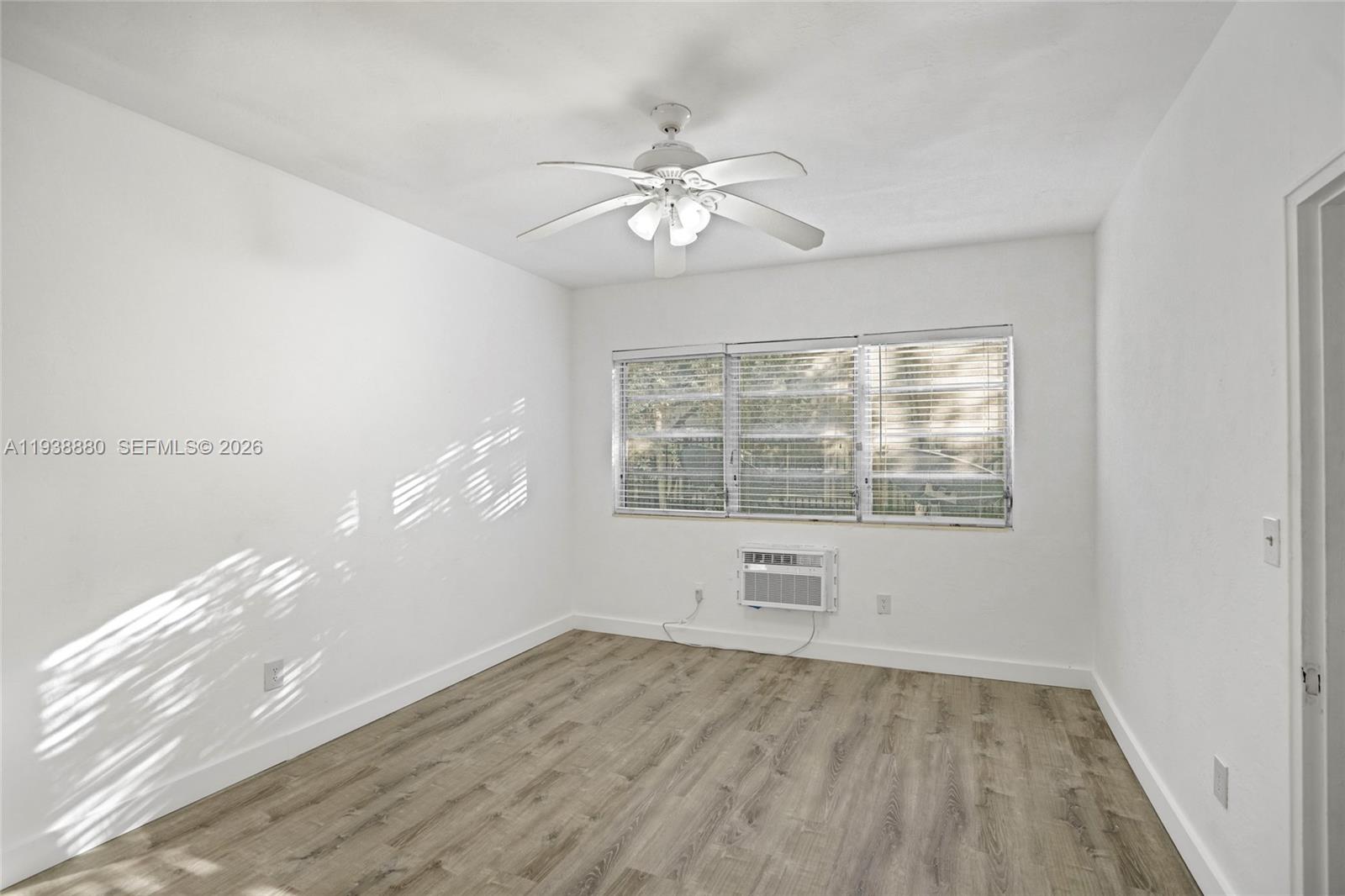 4172 Chase Avenue, Unit 3 Miami Beach, FL 33140 - Photo 19 of 29 a view of a livingroom with a ceiling fan and window