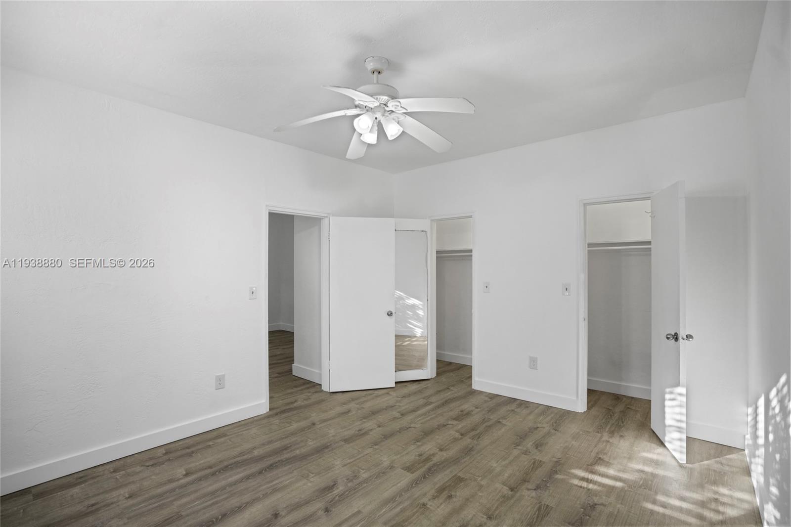 4172 Chase Avenue, Unit 3 Miami Beach, FL 33140 - Photo 21 of 29 an empty room with wooden floor and ceiling fan