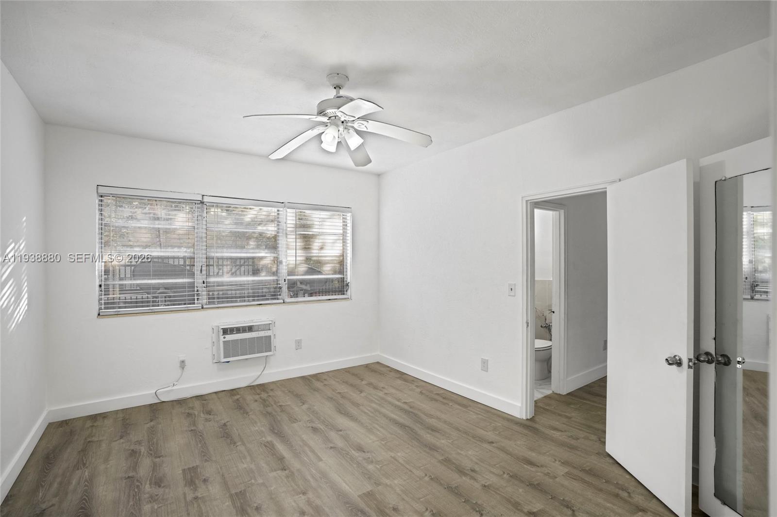 4172 Chase Avenue, Unit 3 Miami Beach, FL 33140 - Photo 4 of 29 wooden floor in an empty room with a window