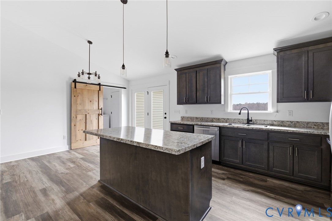 5245 Courtland Road Disputanta, VA 23842 - Photo 7 of 27 a kitchen with granite countertop a sink cabinets and wooden floor