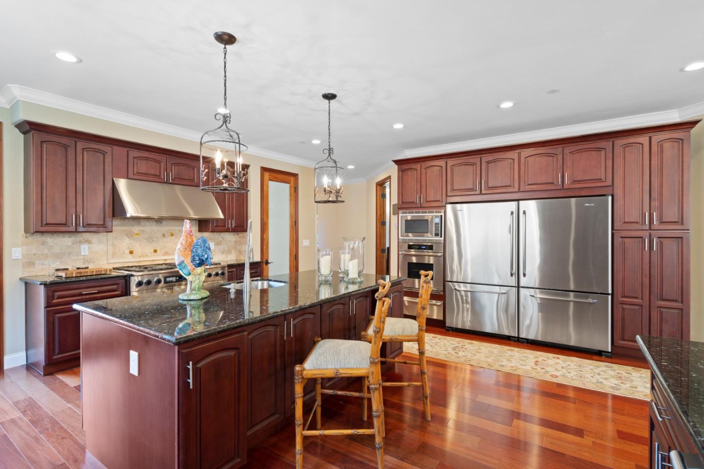 15525 Vía Eduardo Morgan Hill, CA 95037 - Photo 10 of 25 a kitchen with stainless steel appliances granite countertop a refrigerator a stove and a sink with wooden floor