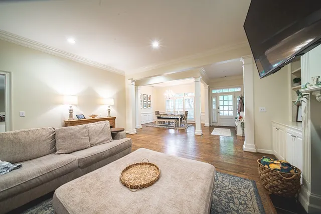 a kitchen with stainless steel appliances granite countertop a refrigerator a stove top oven a sink dishwasher a dining table and chairs