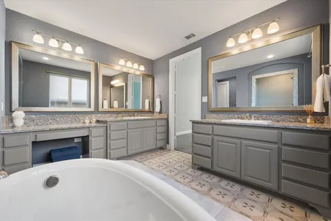 a spacious bathroom with a sink double vanity and a mirror