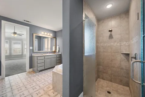 a bathroom with a granite countertop sink mirror and shower