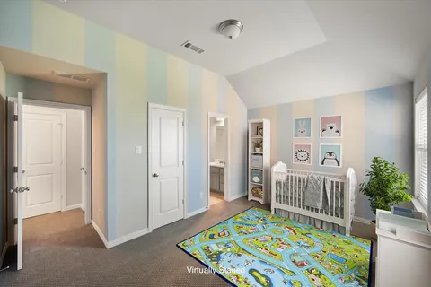 a bedroom with furniture and baby crib