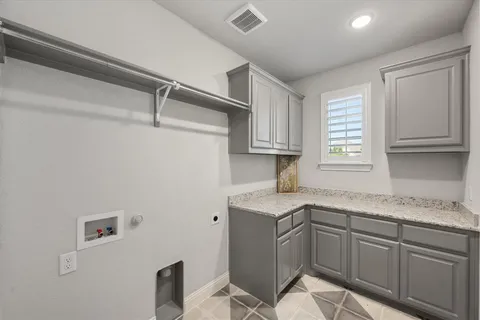 a kitchen with a sink cabinets and window