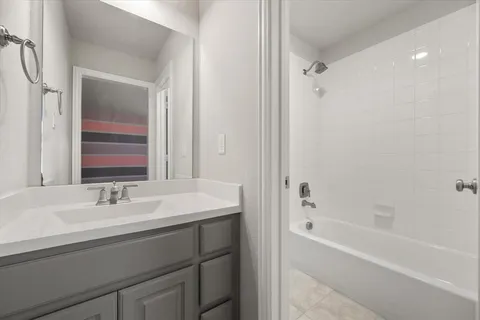 a bathroom with a bathtub and a sink