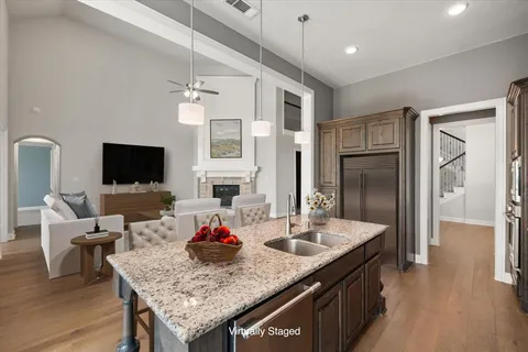 a kitchen with a table chairs refrigerator and microwave