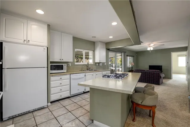a kitchen with white cabinets and white appliances