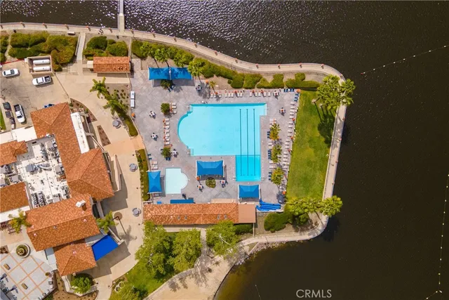 an aerial view of a residential houses with yard