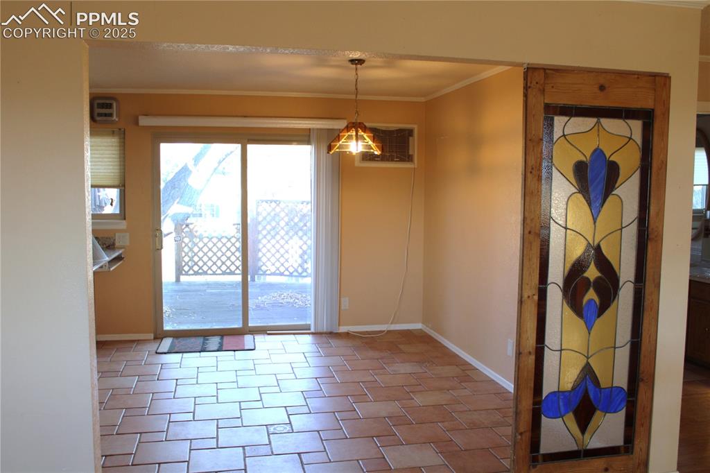 8340 Piute Road Colorado Springs, CO 80926 - Photo 11 of 48 Dining area featuring crown molding