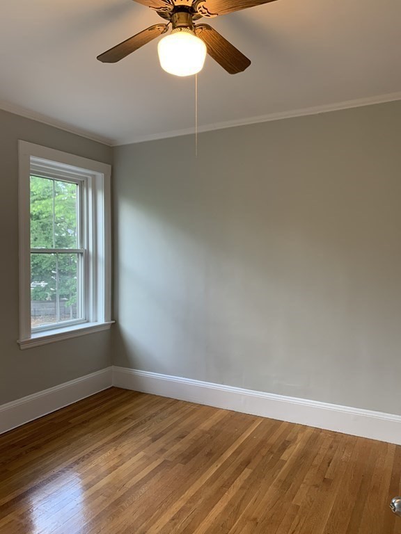 38 Kilsyth Road, Unit 33 Brookline, MA 02445 - Photo 17 of 23 an empty room with wooden floor fan and windows