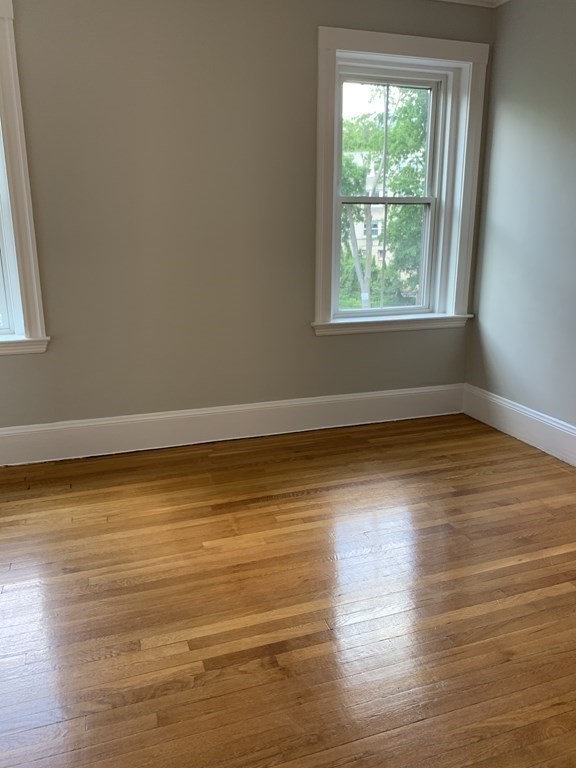 38 Kilsyth Road, Unit 33 Brookline, MA 02445 - Photo 5 of 23 a view of an empty room with wooden floor and a window