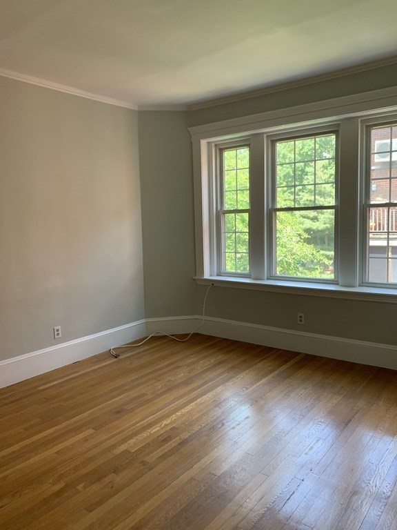 38 Kilsyth Road, Unit 33 Brookline, MA 02445 - Photo 8 of 23 a view of an empty room window and wooden floor