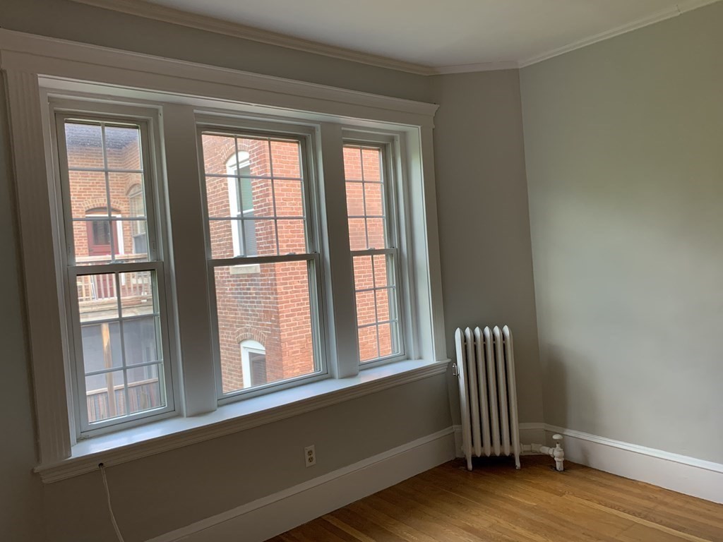 38 Kilsyth Road, Unit 33 Brookline, MA 02445 - Photo 9 of 23 a view of empty room with wooden floor and fan