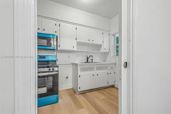 a kitchen with cabinets appliances and a counter top