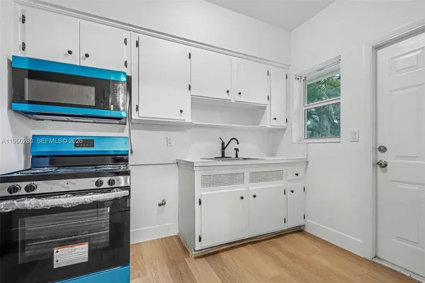 a kitchen with stainless steel appliances a stove microwave and cabinets