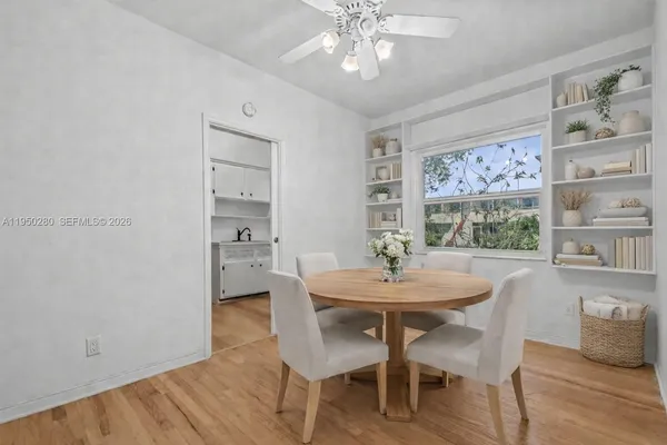 a view of a dining room with furniture and wooden floor
