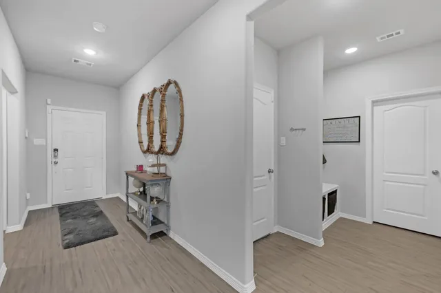 a view of a livingroom with wooden floor and workspace