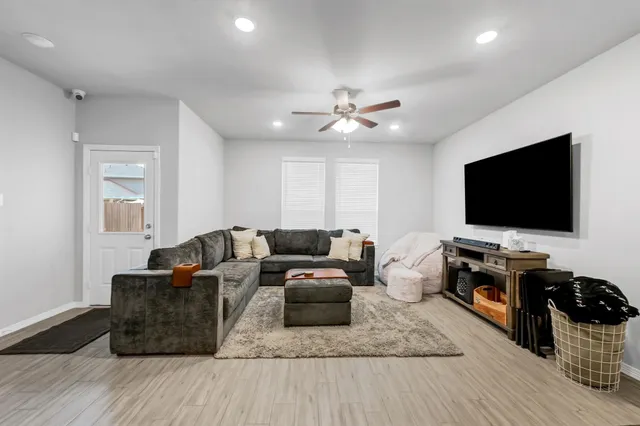 a living room with furniture and a flat screen tv