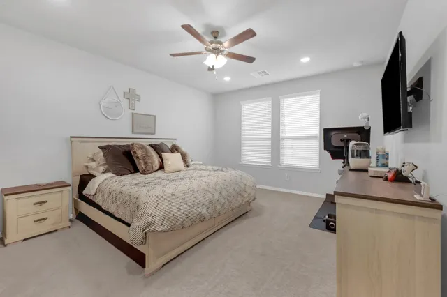 a bed room with a bed and a flat screen tv