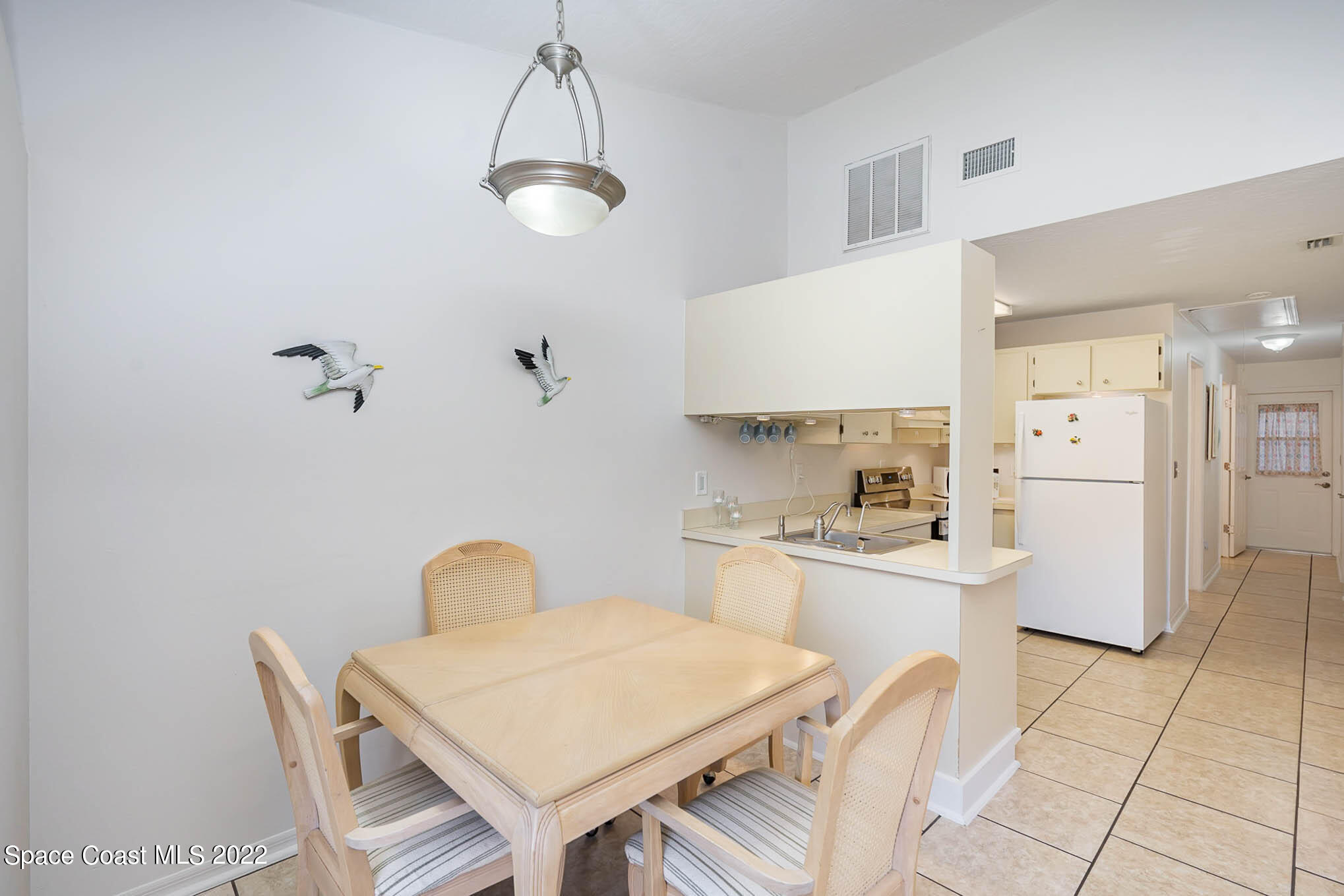8520 Highway 1, Unit G3 Micco, FL 32976 - Photo 15 of 24 a kitchen with a table chairs and a refrigerator