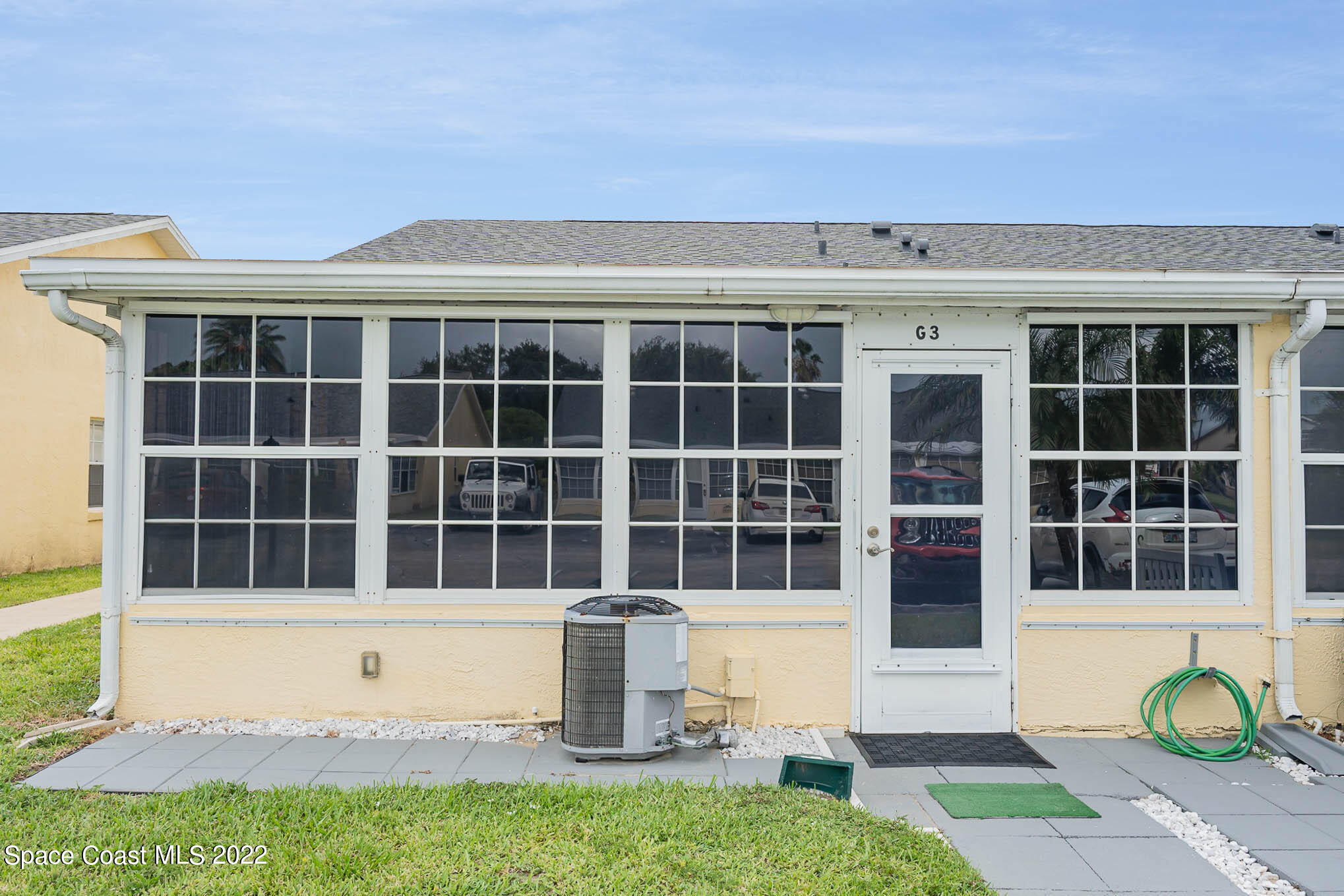 8520 Highway 1, Unit G3 Micco, FL 32976 - Photo 20 of 24 a front view of a house with a garden