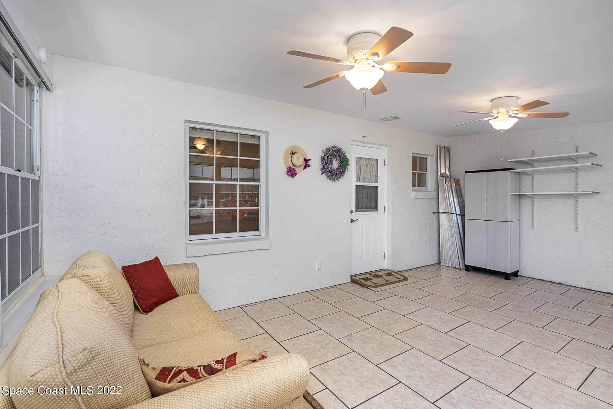 8520 Highway 1, Unit G3 Micco, FL 32976 - Photo 3 of 24 a bedroom with a large bed and a chandelier
