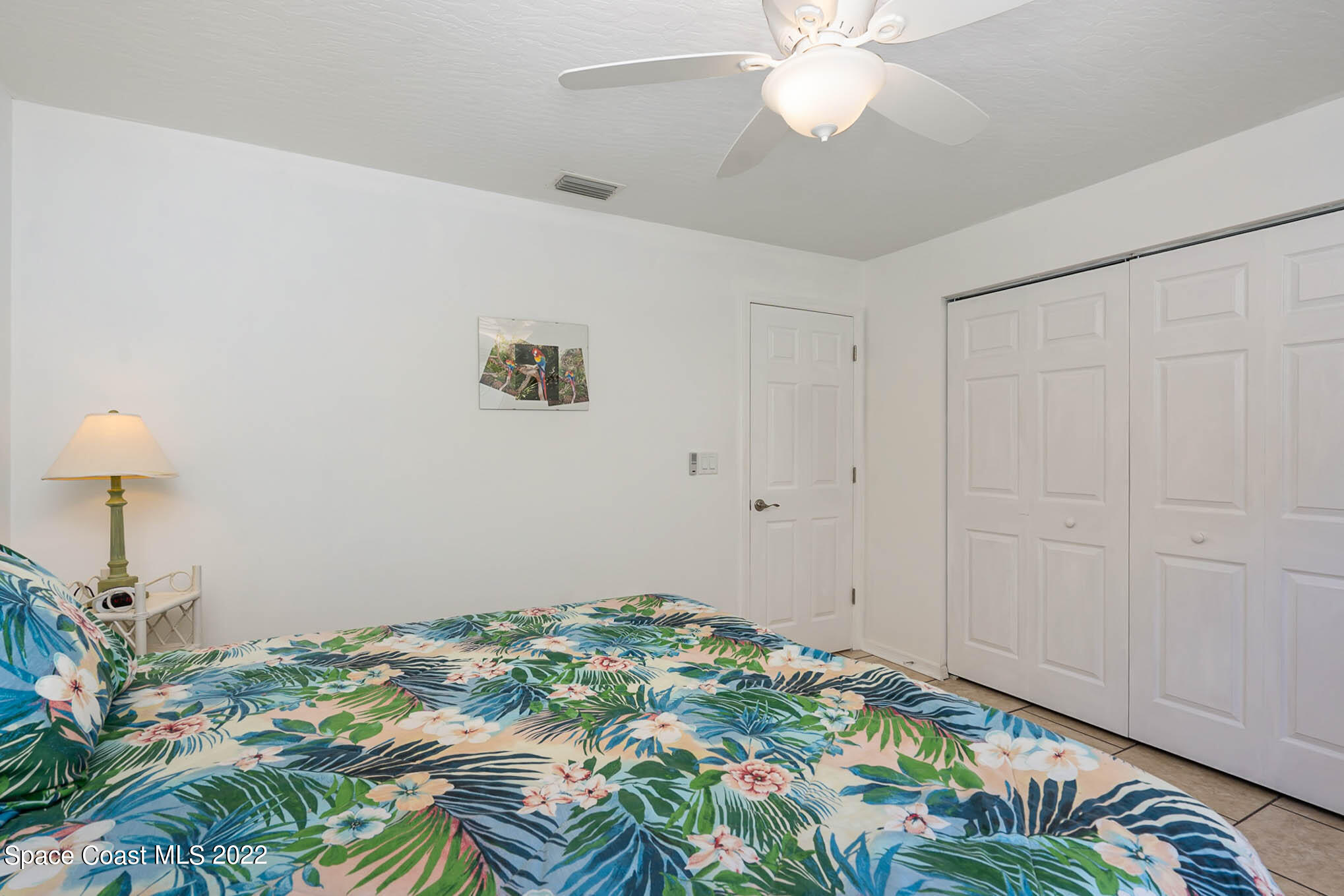 8520 Highway 1, Unit G3 Micco, FL 32976 - Photo 8 of 24 a bedroom with a bed and a chandelier fan