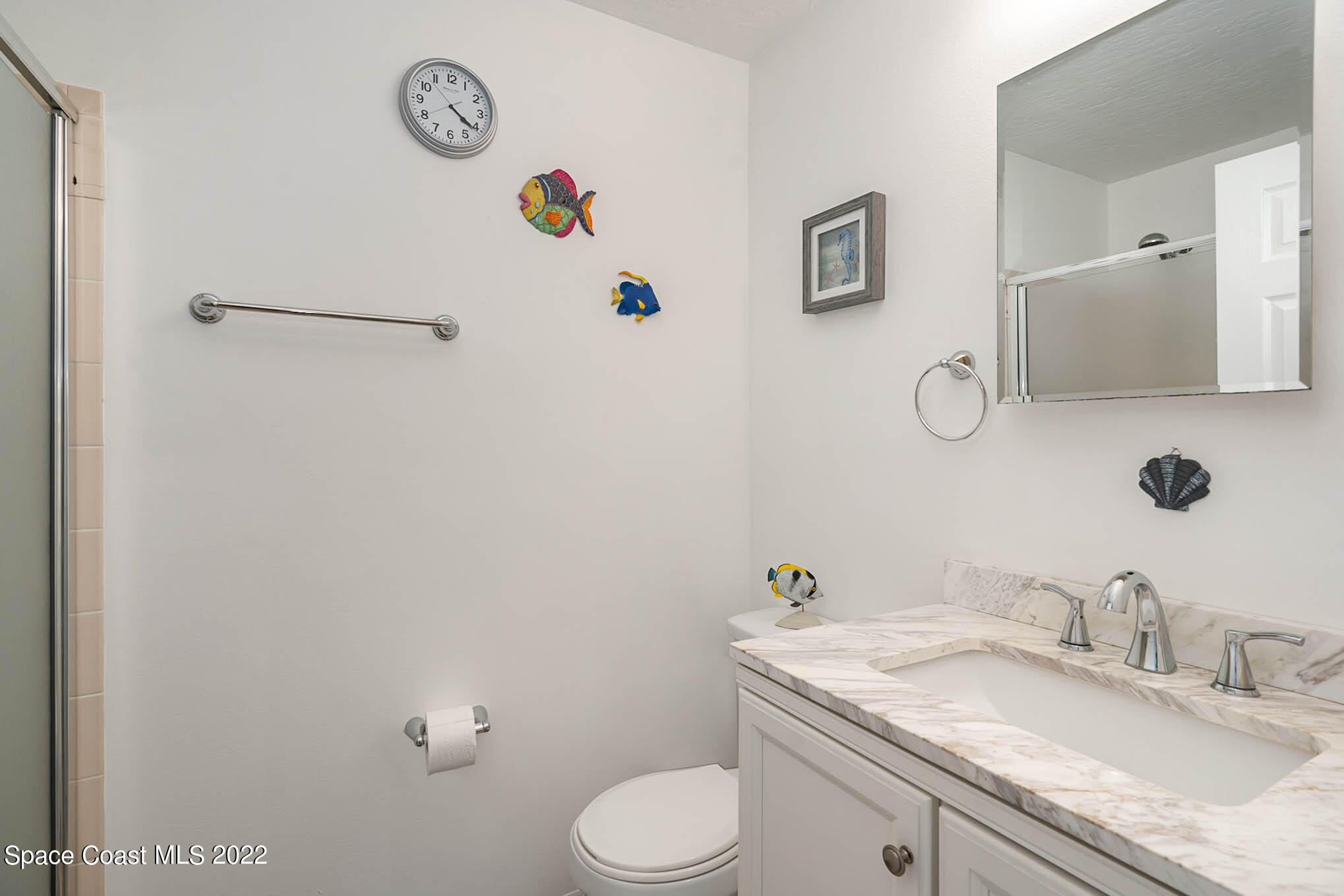 8520 Highway 1, Unit G3 Micco, FL 32976 - Photo 9 of 24 a bathroom with a granite countertop sink mirror vanity and toilet