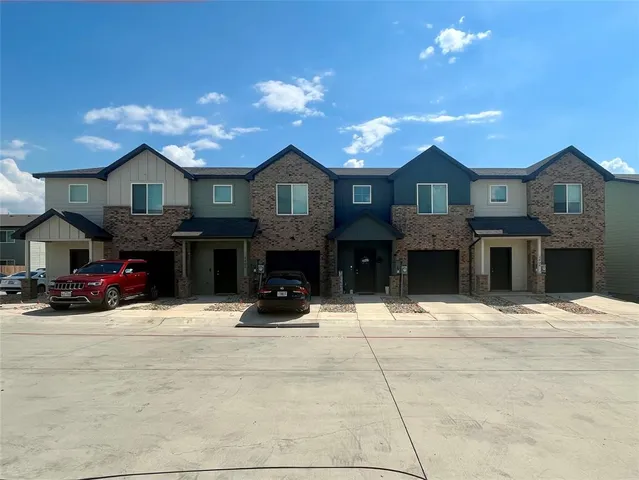 a view of a house with a yard and garage