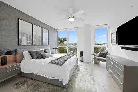 a bedroom with a large bed and a flat screen tv