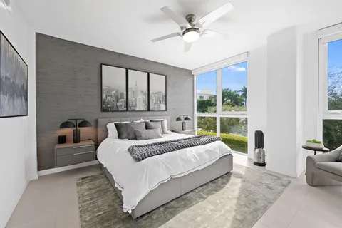 a bedroom with a large bed and a chandelier