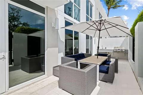 a patio with a table and chairs