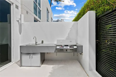 a view of a kitchen with a sink and cabinets