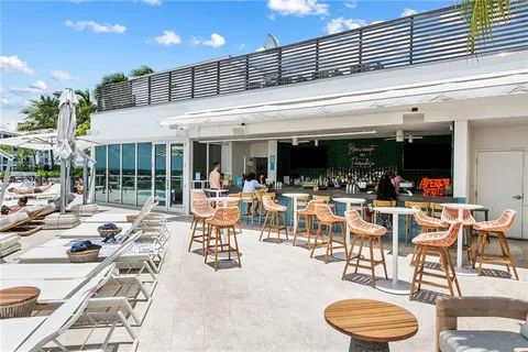 a view of a patio with dining table and chairs