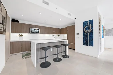 a kitchen with stainless steel appliances granite countertop a sink and a refrigerator