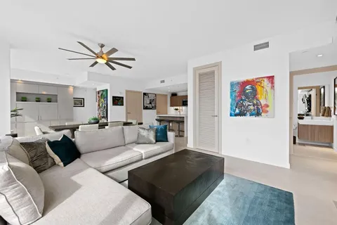 a living room with furniture ceiling fan and a rug