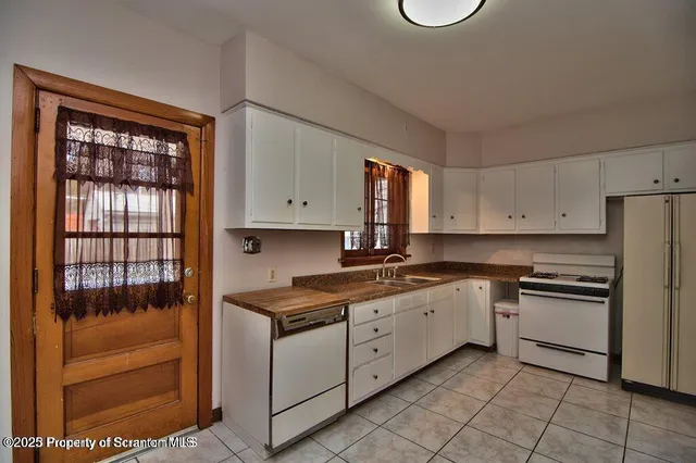 a kitchen with a stove a sink and a refrigerator