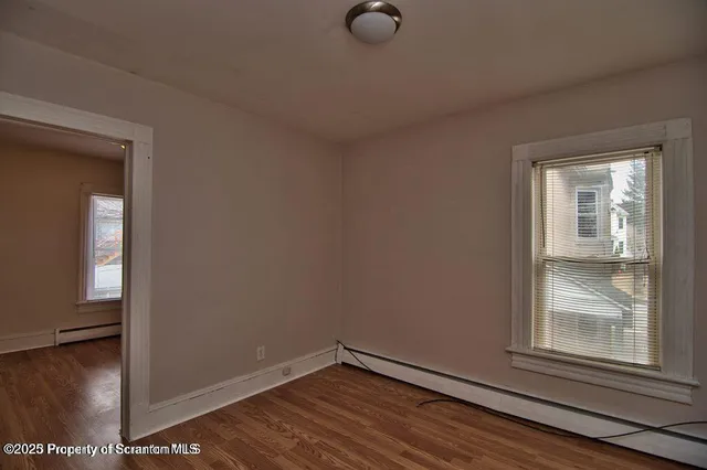 an empty room with windows and closet